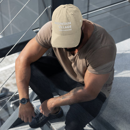 Man sitting and modelling khaki coloured dad hat