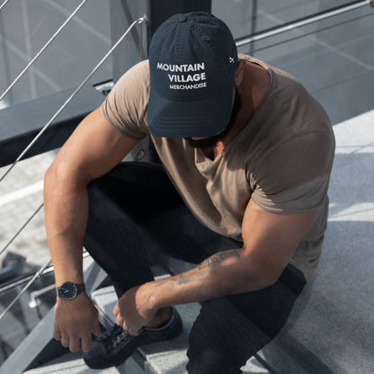 Man sitting modelling navy coloured dad hat